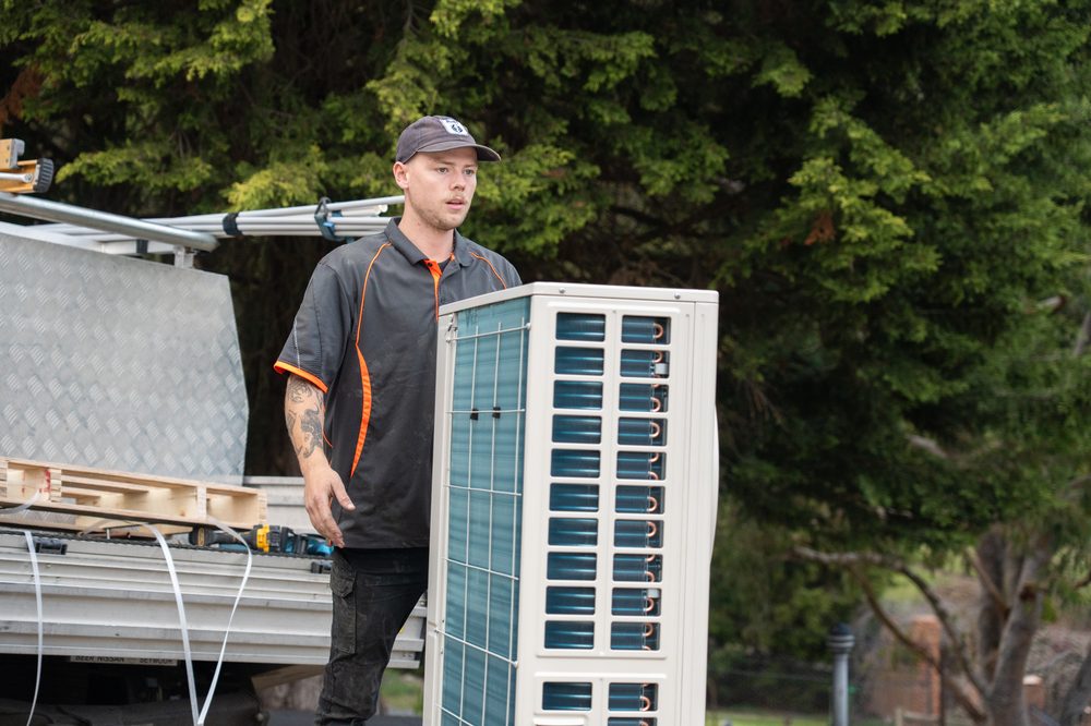 Technician installing a split system