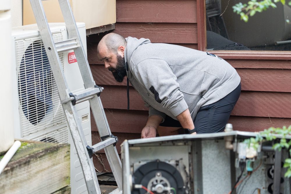 Technician servicing a split system